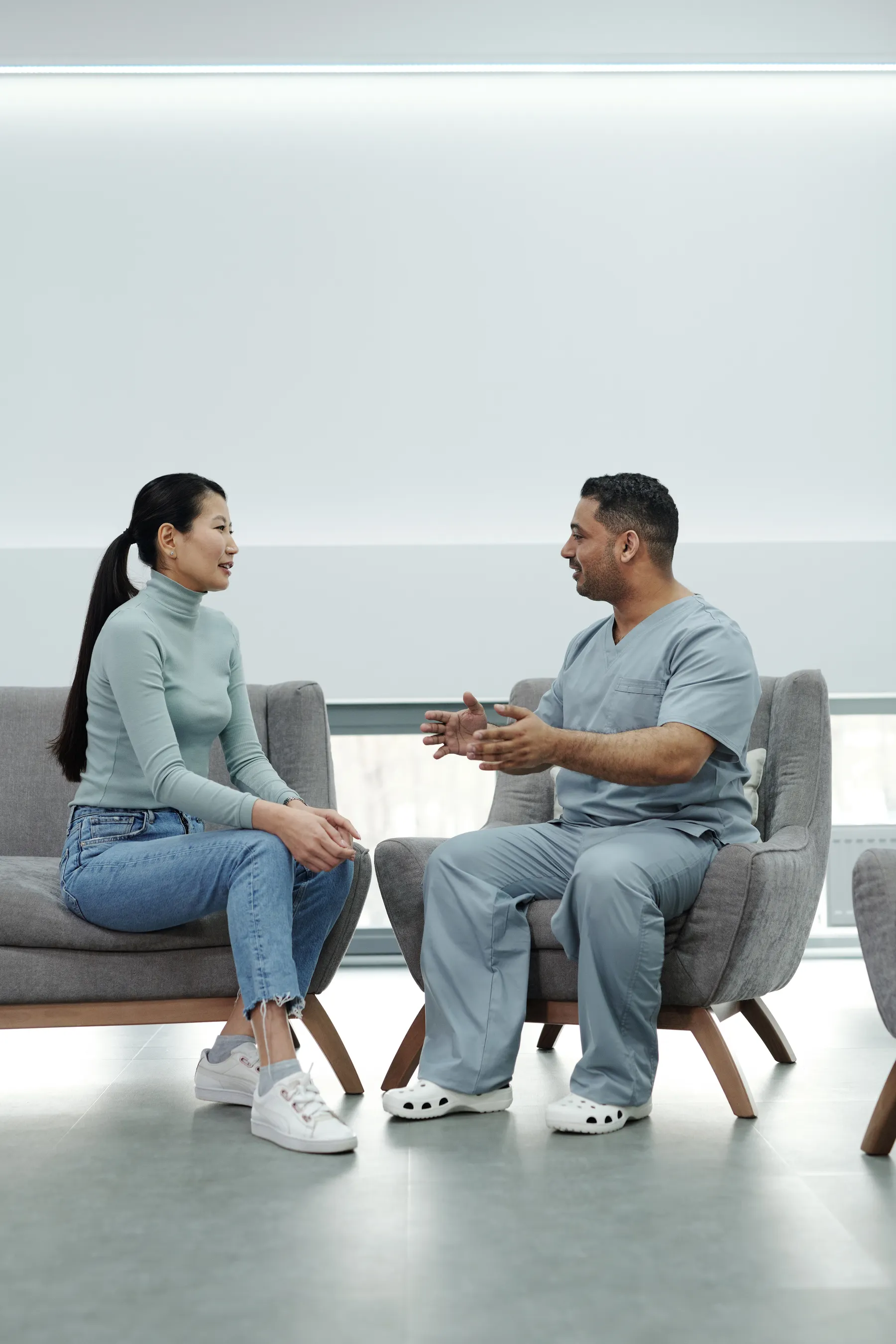 Two people talking through a result in a bright consulting room.