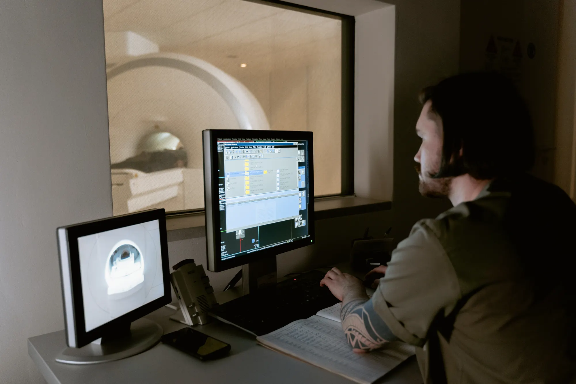 A radiographer reading images at a reporting console.